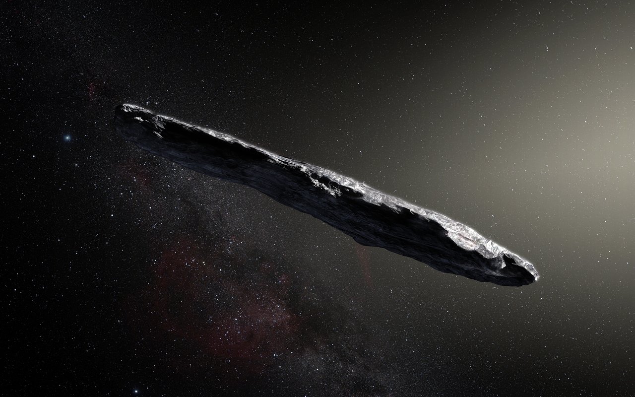 Artist's impression of the interstellar object 'Oumuamua as an elongated, reddish, cigar-shaped body tumbling through space — an illustration, not a photograph.